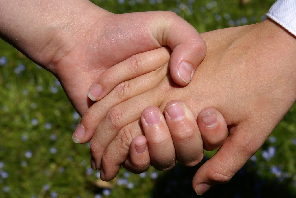 Holding hands. (Credit: fromcolettewithlove/ Flickr)