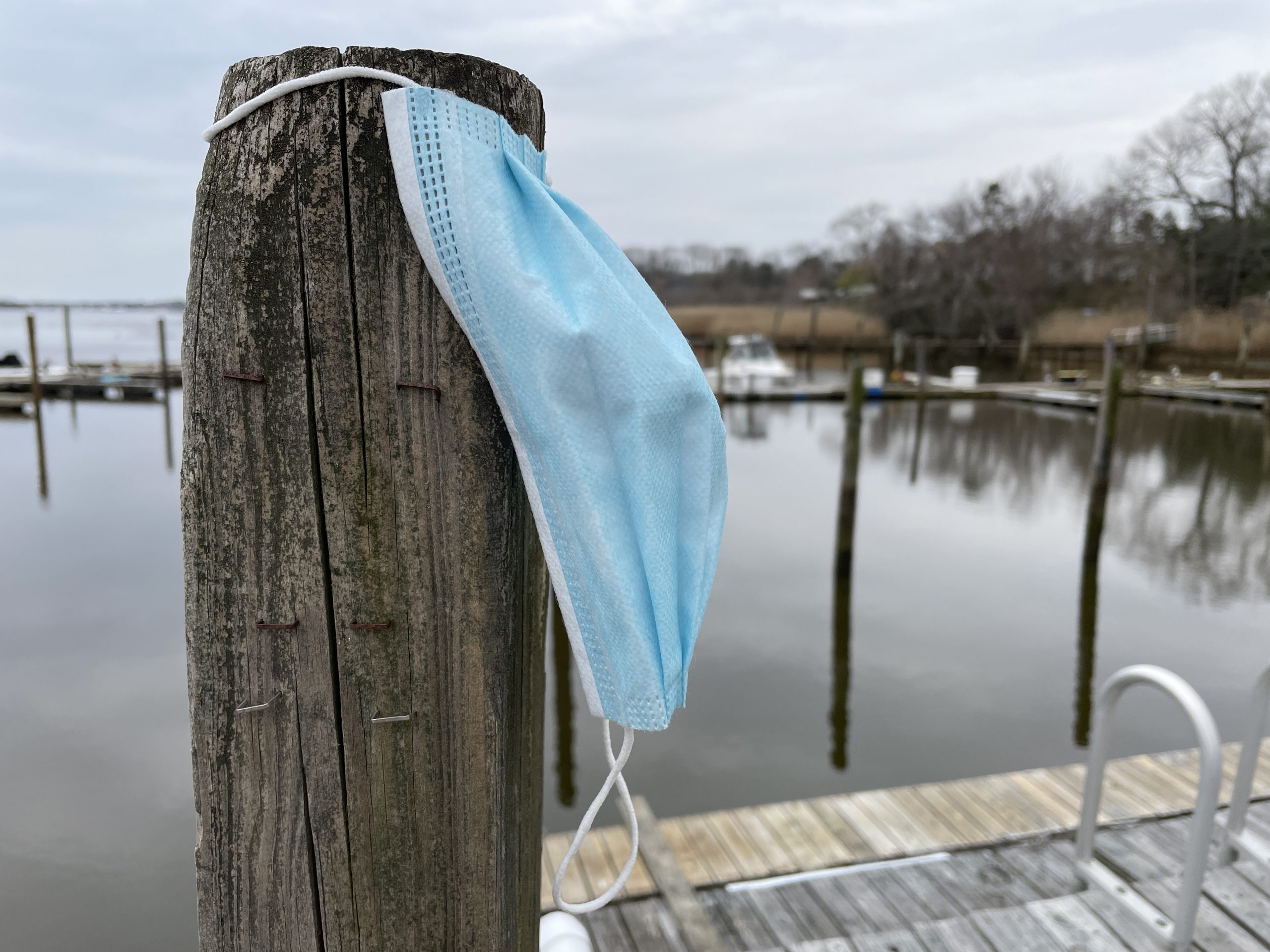 A face mask against a piling at a local marina. (Photo: Daniel Nee)