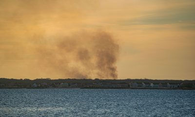 A controlled burn in Ocean County, N.J. produces a plume of smoke over Barnegat Bay, Feb. 28, 2022. (Photo: Daniel Nee)
