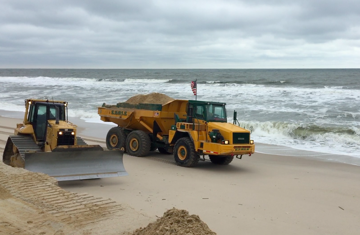 Crews from Earle Asphalt build up makeshift berms in Toms River's portion of Normandy Beach. (Photo: Daniel Nee)