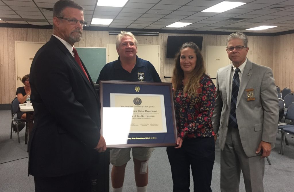 Chief Thomas Boyd (center) accepts a plaque nothing the accreditation of his department. (Photo: Daniel Nee)