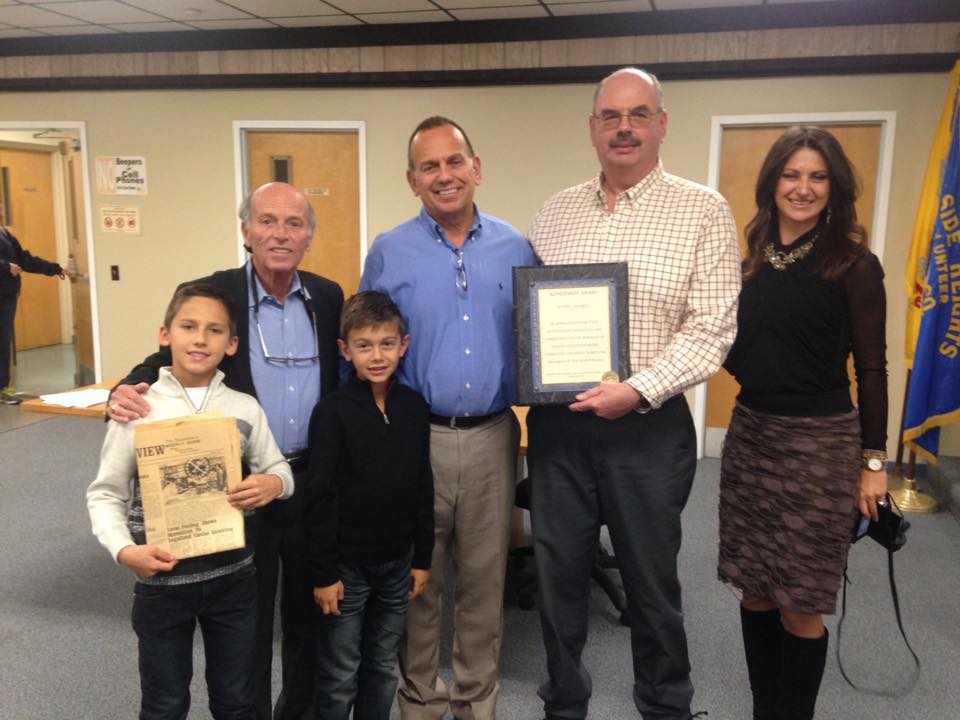 Mayor Anthony Vaz and Councilman Richard Tompkins present a resolution to Wayne Cimorelli and his family. (Photo: Daniel Nee)