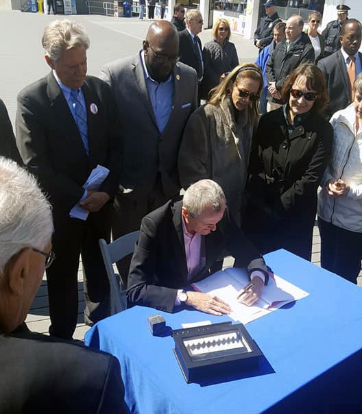 Local officials join Gov. Phil Murphy in signing legislation banning offshore drilling in New Jersey. (Photo Courtesy: Jim Fozman)