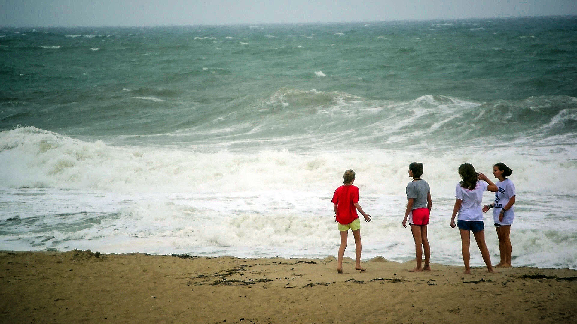 Visitors on the sand in Orltey Beach during the July 21, 2018 storm. (Photo: Daniel Nee)
