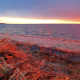 The sun provides a stunning flash before setting between clouds, Jan. 28, 2023. (Photo: Daniel Nee)