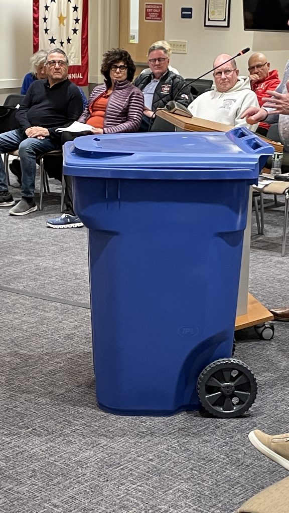 A representative from IPL Global shows off his company's tipper can (robo-can) for garbage collection, March 2023. (Photo: Daniel Nee)