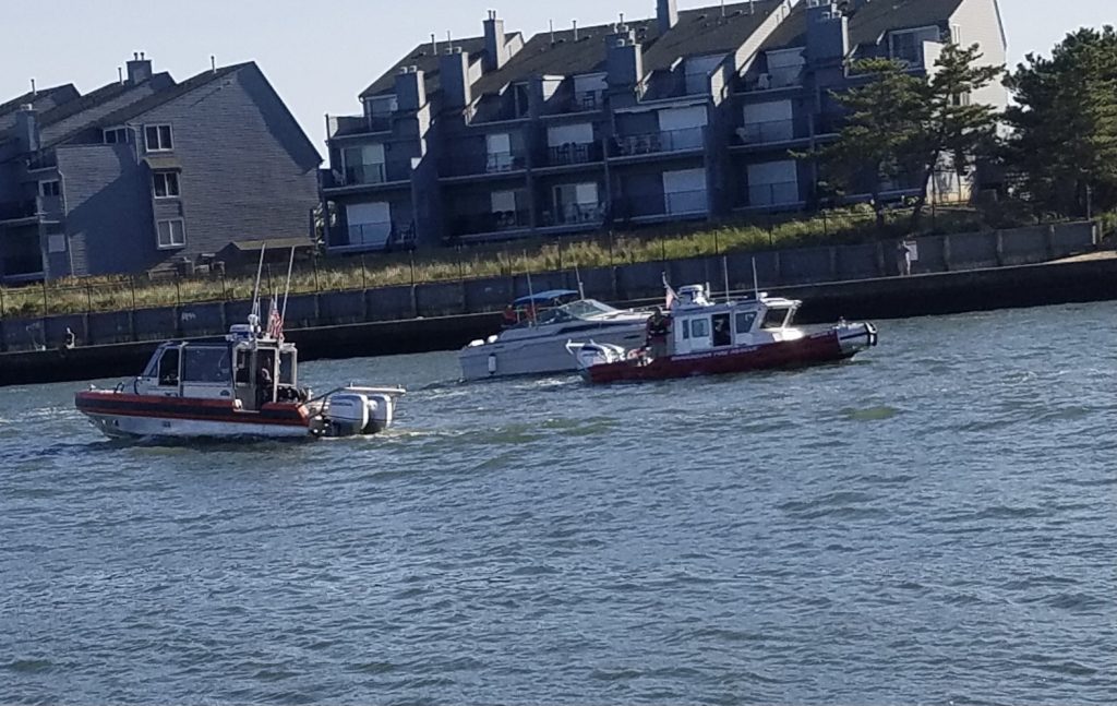 A boat is disabled and secured by the U.S. Coast Guard and Brielle Fire-Rescue in Manasquan Inlet, Sept. 22, 2020. (Photo: Patricia Nee)
