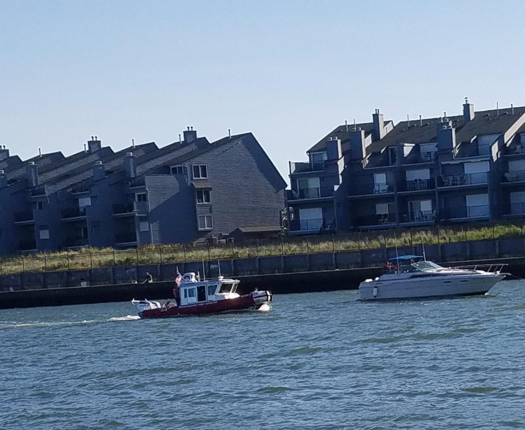 A boat is disabled and secured by the U.S. Coast Guard and Brielle Fire-Rescue in Manasquan Inlet, Sept. 22, 2020. (Photo: Patricia Nee)