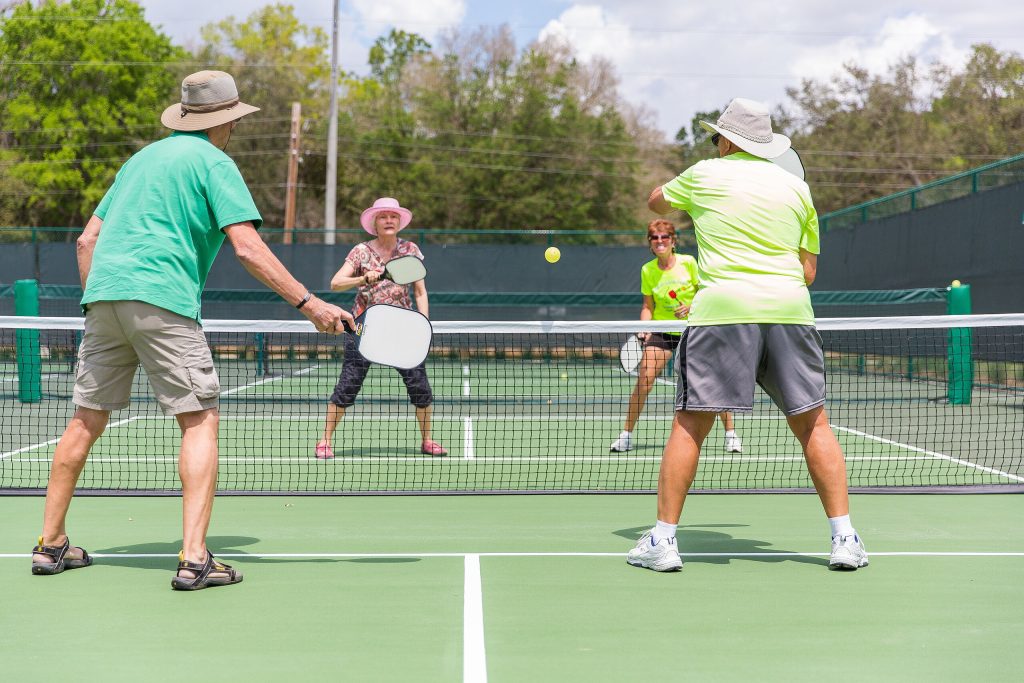 A group plays Pickleball at a purpose-built court. (Credit: Openverse/ Creative Commons)